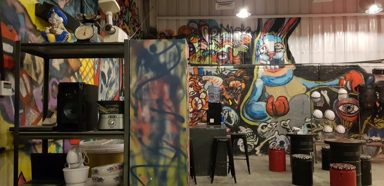 Graffiti walls, murals, and old appliances welcome you