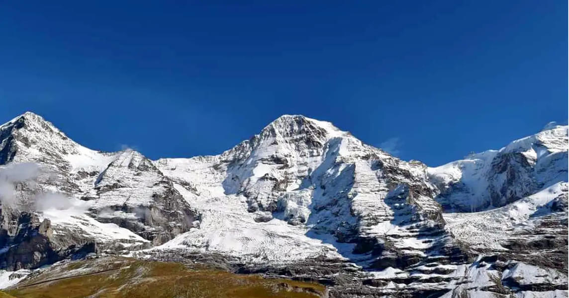 Admire the beauty of snow-capped mountains