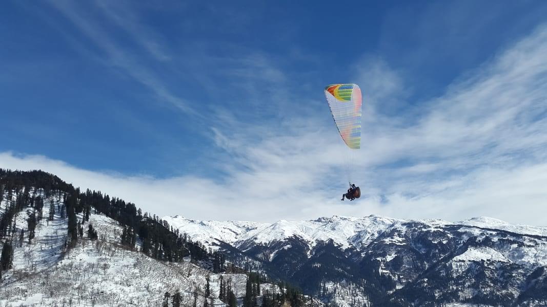 Capture amazing photographs and videos as you paraglide over the scenic areas of Manali.