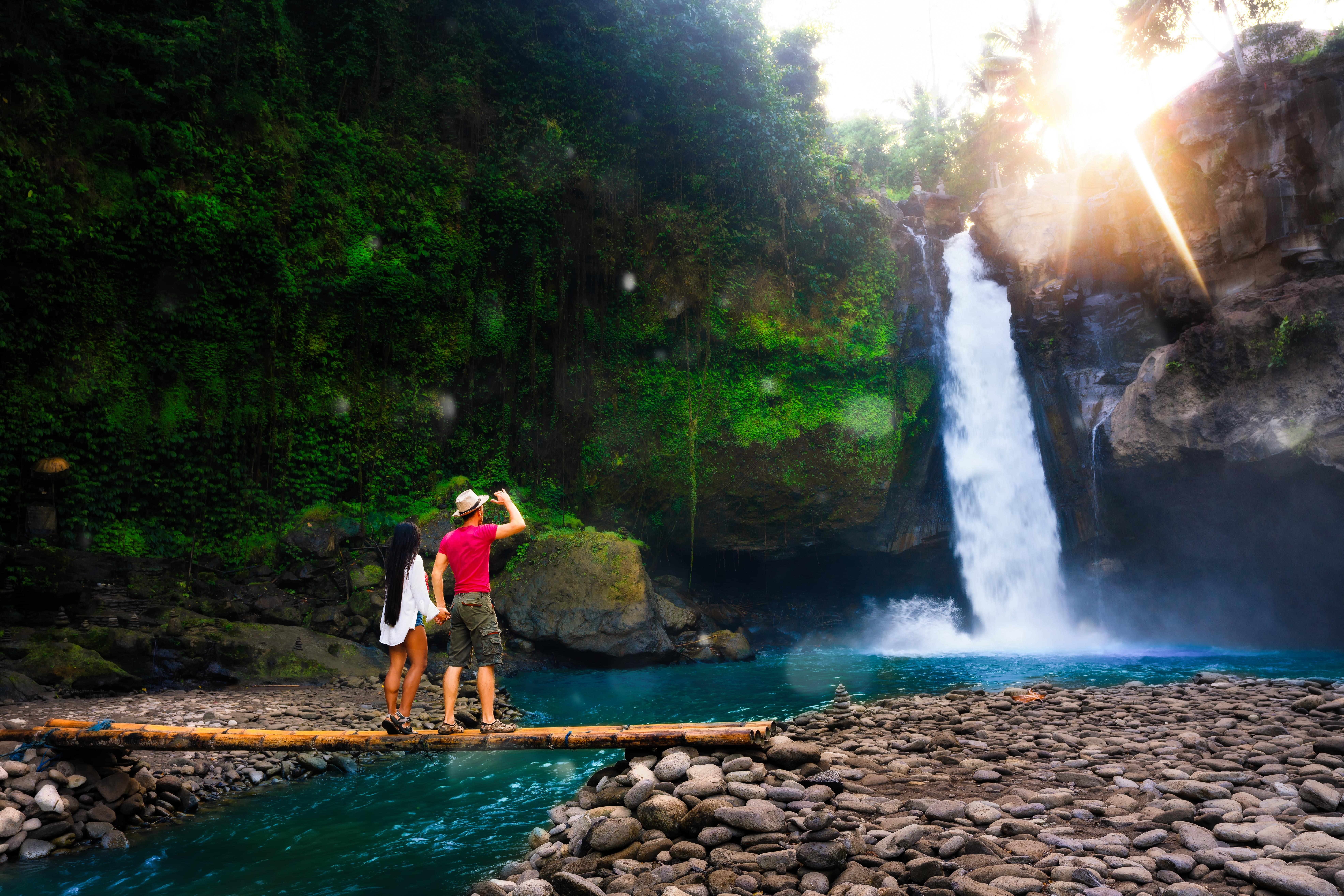 Couple admiring a gorgeous waterfall in Bali