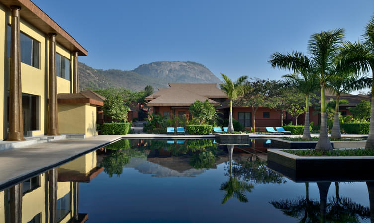 Take a relaxing dip inside the pool with a beautiful backdrop of Nandi hills