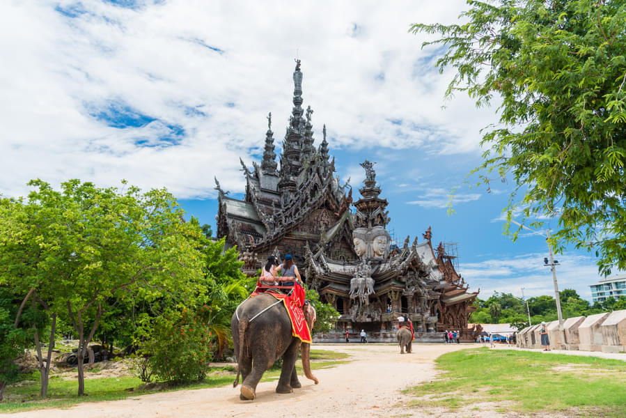 Take part in various activities like elephant riding at Thailand's famous ornate wood temple