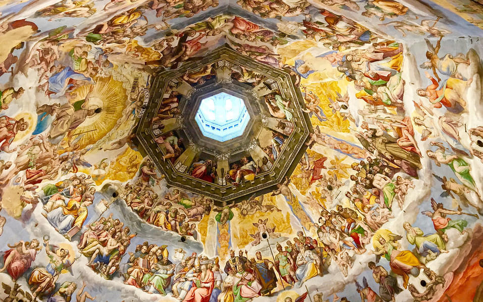 Observe the beautiful fresco art across the chapel's ceiling
