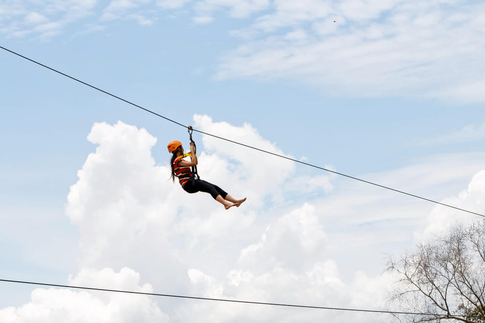 Glide 150 meters across Coorg’s lush forests, enjoying a thrilling zip-lining experience.