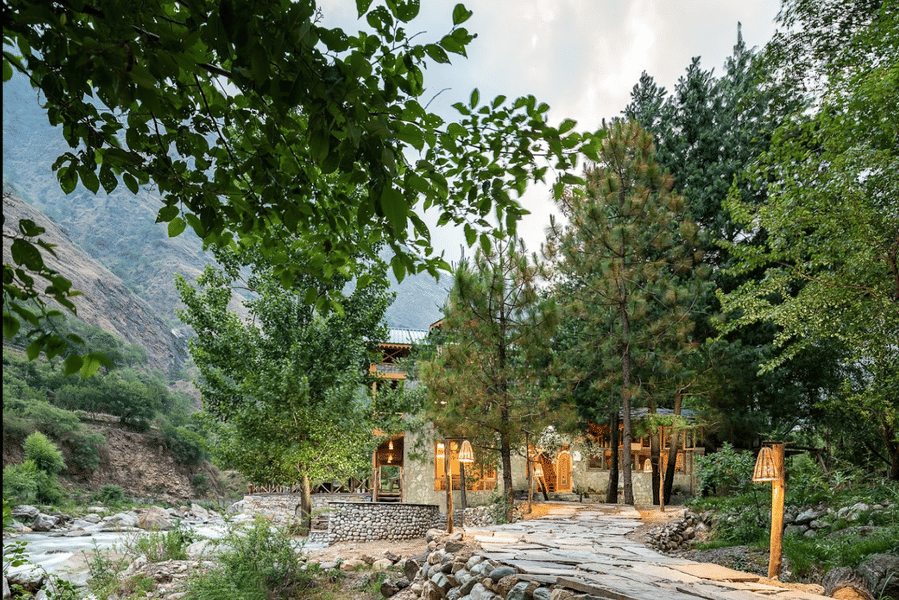 A Riverside Cottage Amidst Lush Greens Of Tirthan Valley Image