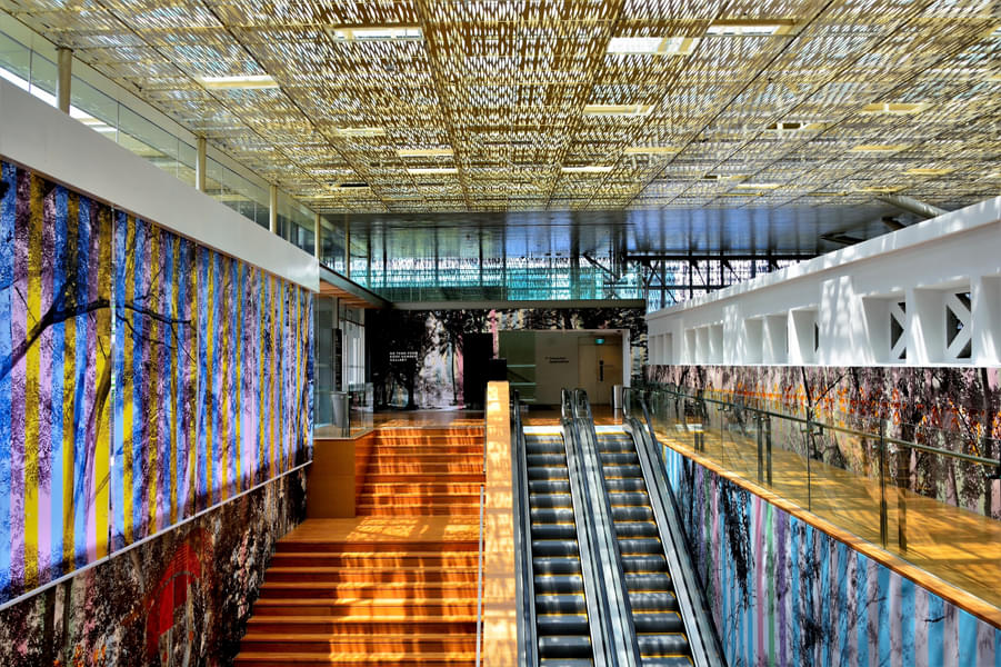 Interior of National Gallery Singapore atrium staircase and escalators