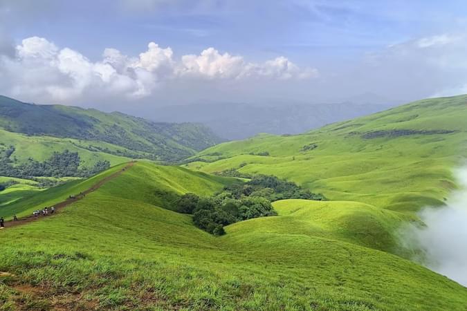 Marvel at stunning views of lush valleys and serene landscapes from Netravathi Peak