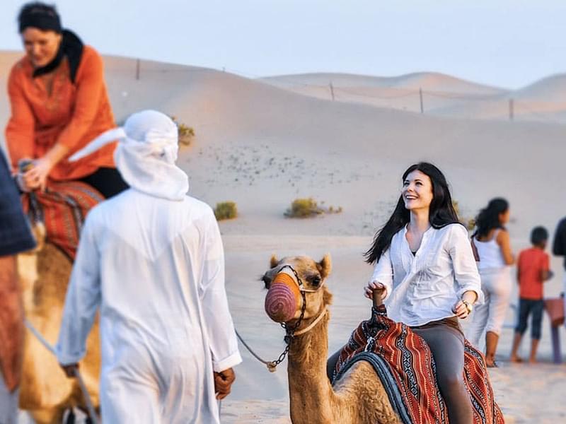 Camel riding with the help of experts.