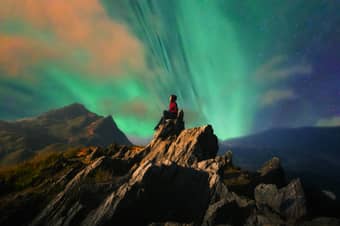 Girl enjoying the view of Northern Lights, Iceland
