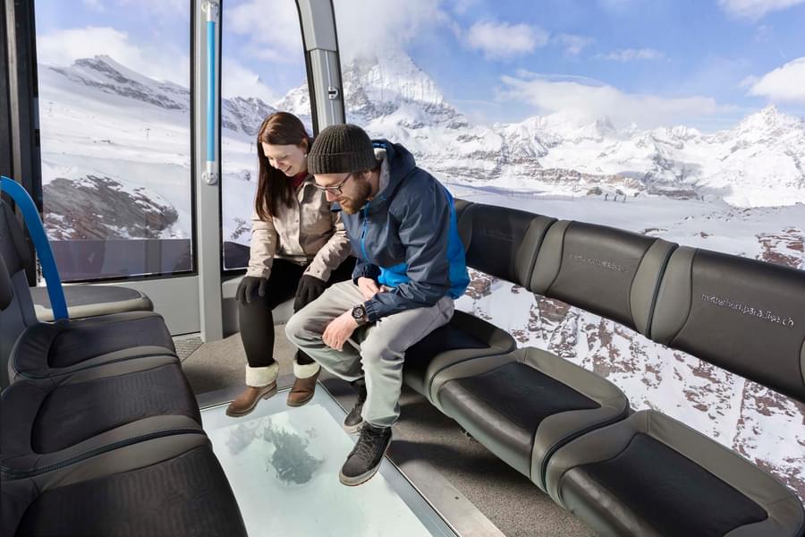 Witness the pristine views of the snow while sitting comfortably in a cable car
