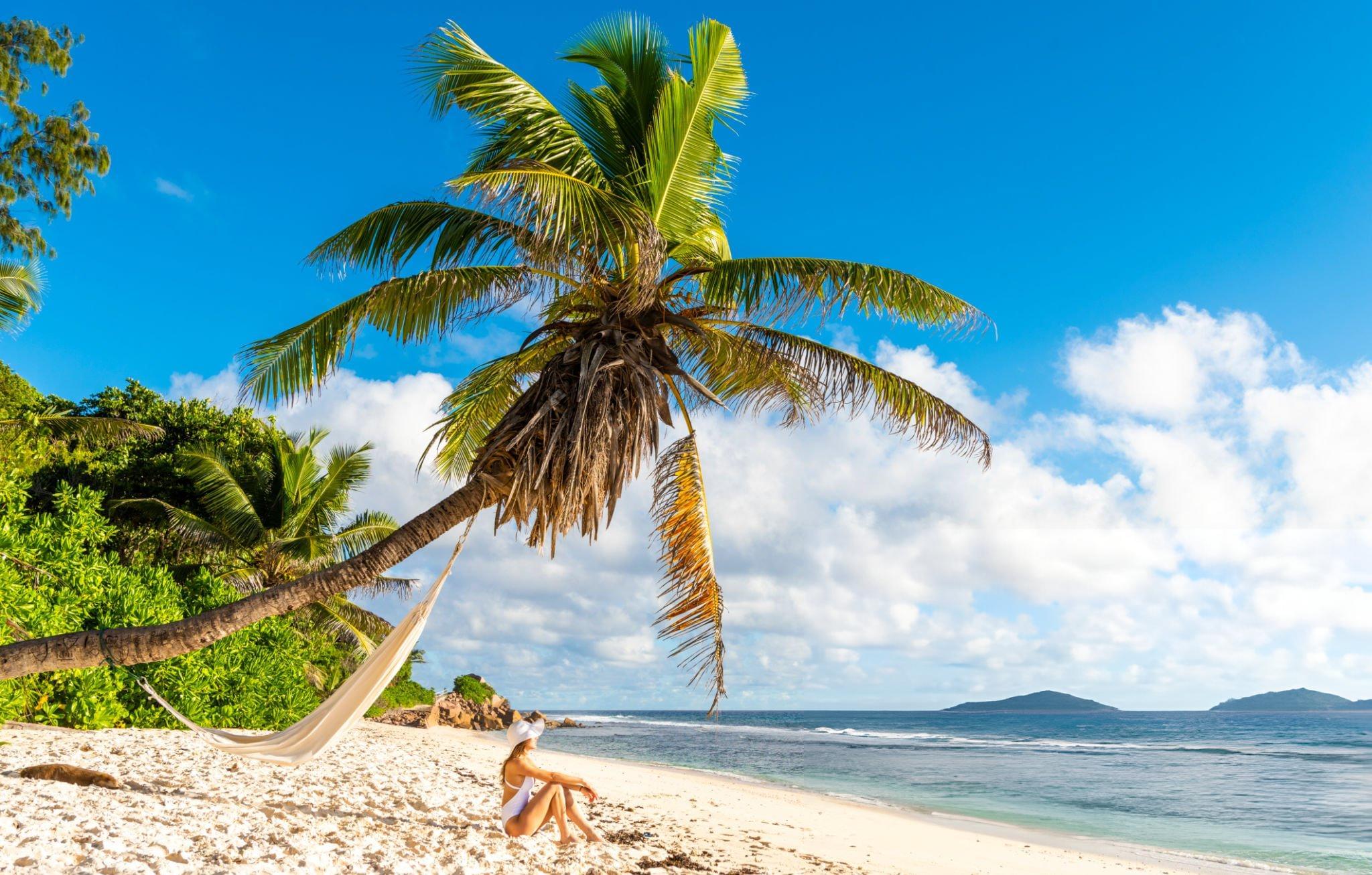 Tourist relaxing on a beach in Mahe Island