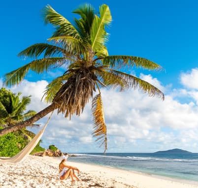 Tourist relaxing on a beach in Mahe Island