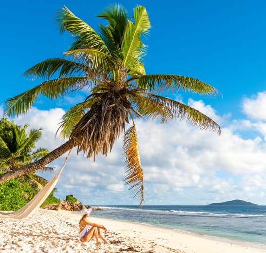Tourist relaxing on a beach in Mahe Island
