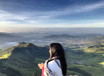 Embark on the Kolukkumalai Tea Estate Trek, starting with an overnight journey from Bangalore