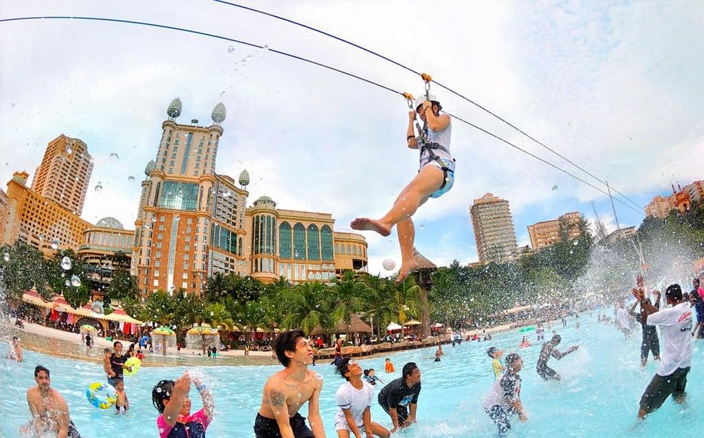Glide over the pool of the park on a zipline adventure