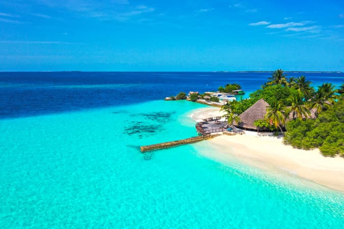 Stay in a beachfront bungalow, steps away from the turquoise lagoon