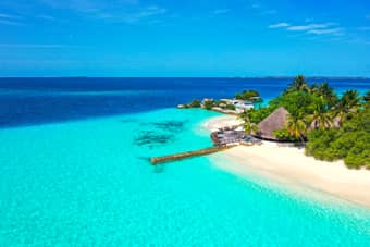 Stay in a beachfront bungalow, steps away from the turquoise lagoon