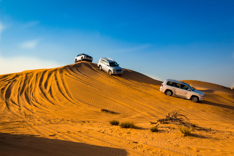 tourists enjoying jeep ride in Dubai Desert