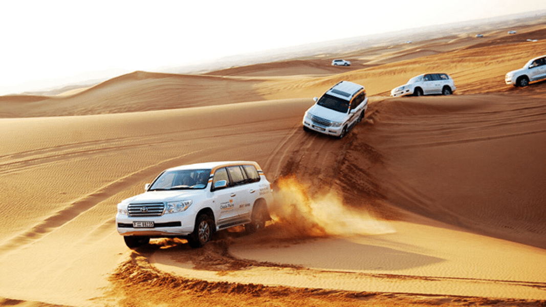 Cars navigating the vast expanse of the picturesque desert landscape.