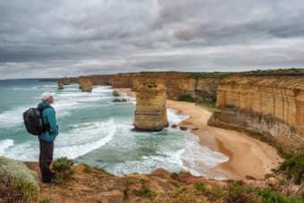 Tourist enjoying views of Twelve Apostles