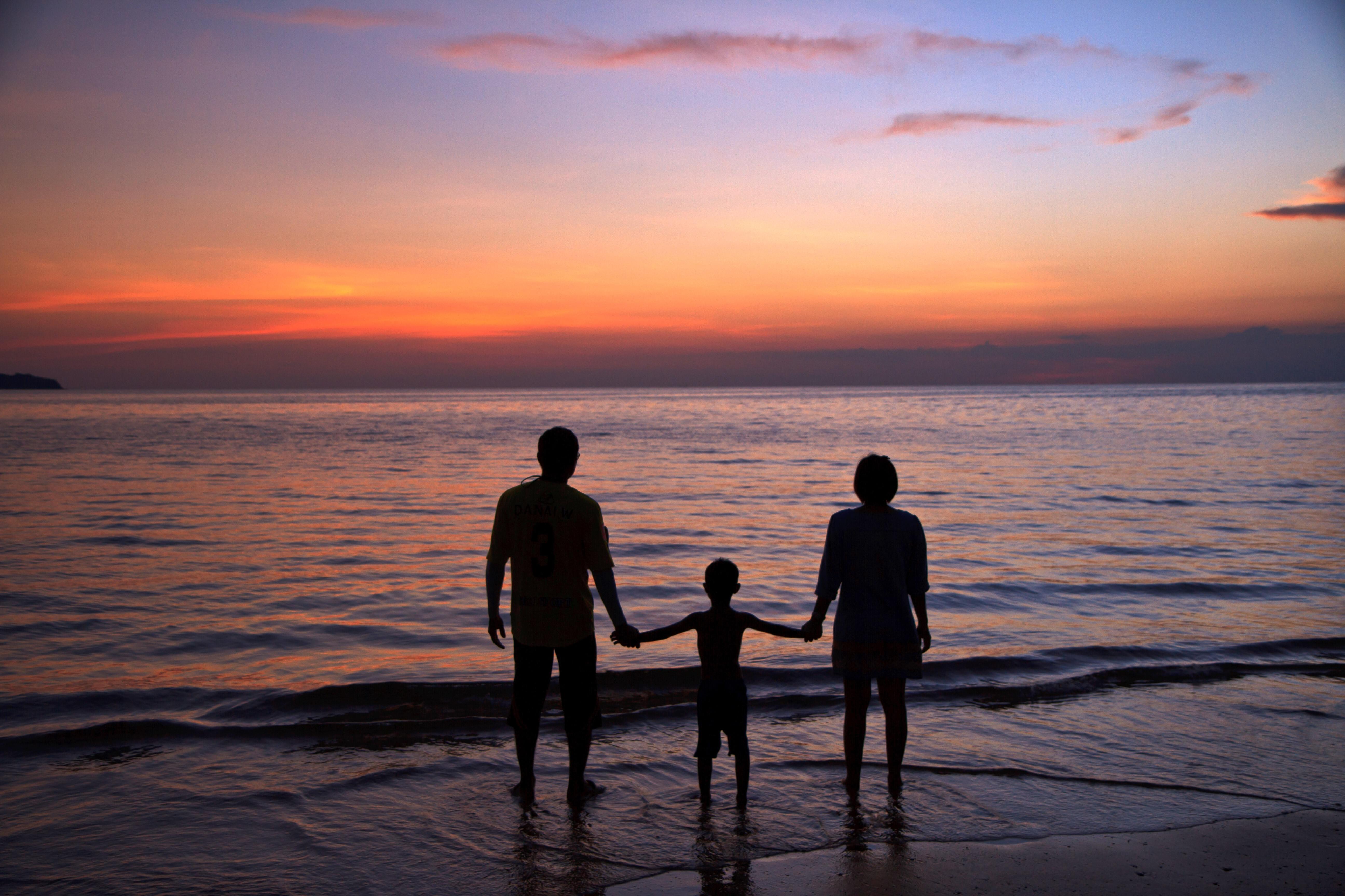 Family enjoying scenic sunset at the beach, Kerala