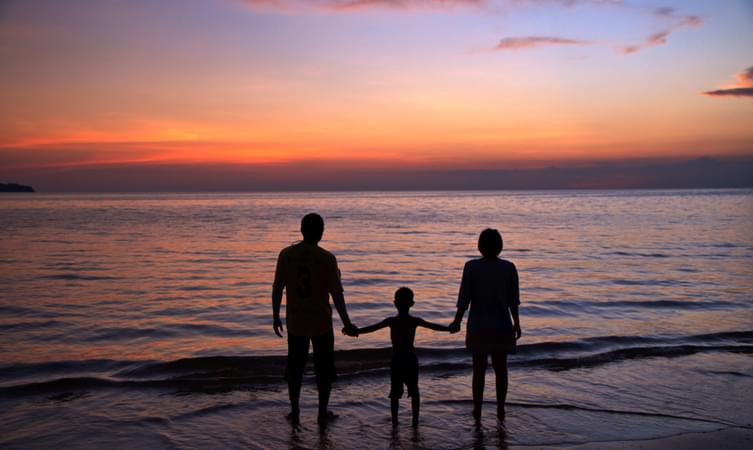 Family enjoying scenic sunset at the beach, Kerala