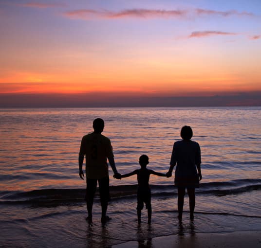 Family enjoying scenic sunset at the beach, Kerala