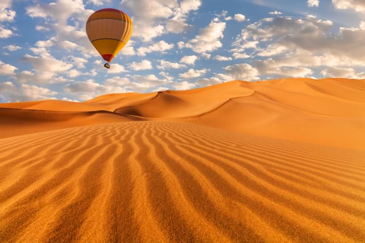 Hot air balloon Flying over the Bright Dubai Desert