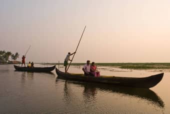 Experience the charm of nightfall on a scenic three-hour backwater ride with dinner