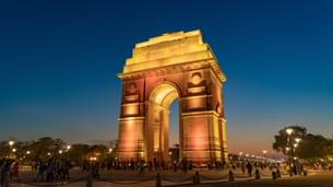 Explore Delhi's iconic landmarks, including a tranquil walk around India Gate, on an immersive 16-hour sightseeing tour