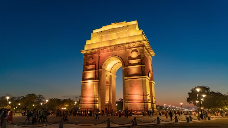 Explore Delhi's iconic landmarks, including a tranquil walk around India Gate, on an immersive 16-hour sightseeing tour