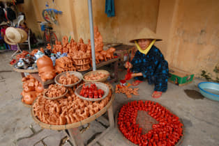 Ppqow0k3jz066j6qe8avkhe9676j an aged woman wearing traditional vietnamese clothes, selling fictile craft souvenirs in one of hoi an ancient town streets