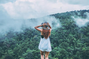 Woman admiring the views of misty mountains