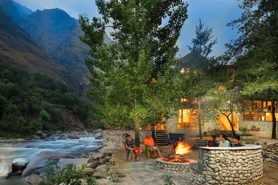 A Riverside Cottage Amidst Lush Greens Of Tirthan Valley Image