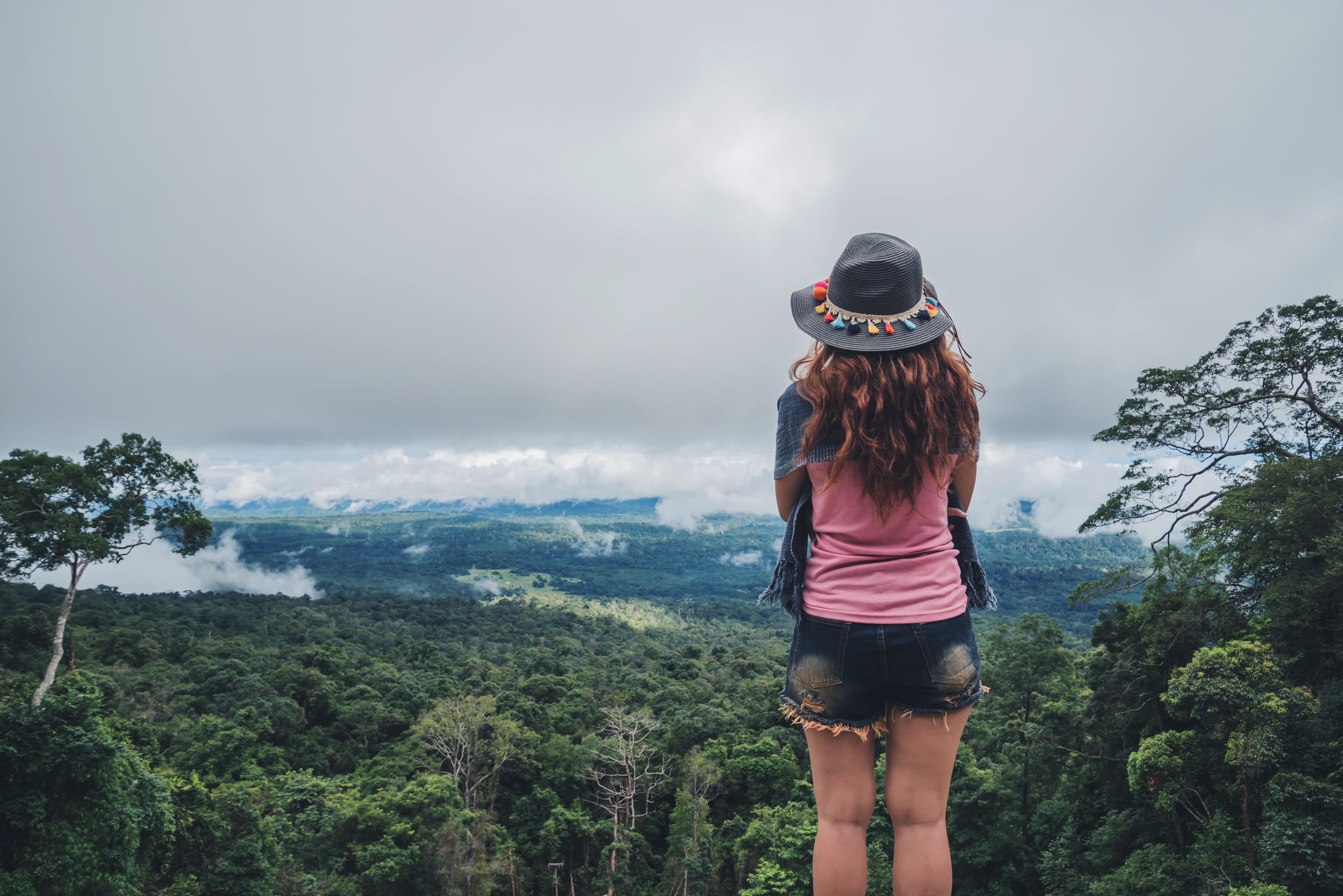 Woman admiring the views of misty mountains