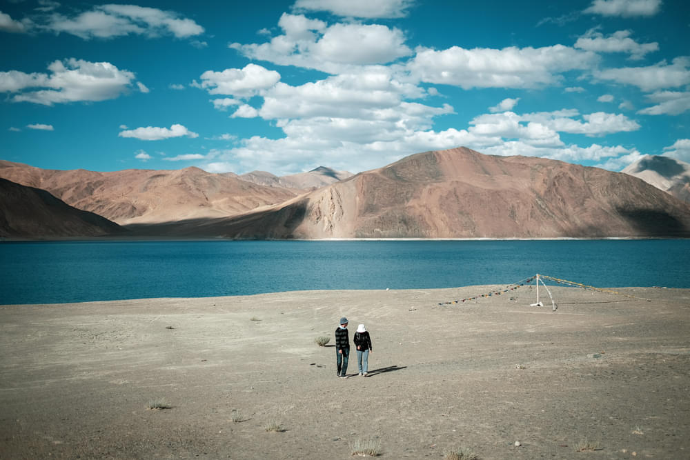 Amidst the tranquil blue waters and picturesque mountains of Pangong Lake where lovebirds create memories for lifetime