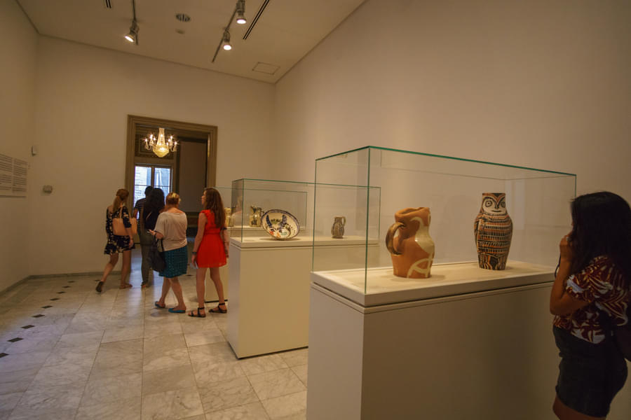 Visitors exploring pottery artefacts at the Picasso Museum, Barcelona