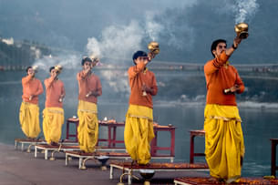Feel the energy of evening Ganga Aarti in Rishikesh, as the air fills with chants and light