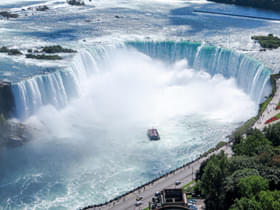 S2ukncelg08breajhwqb30osfhc8 aerial view of the canadian falls (horseshoe falls) and the hornblower niagara cruises boat  niagara falls