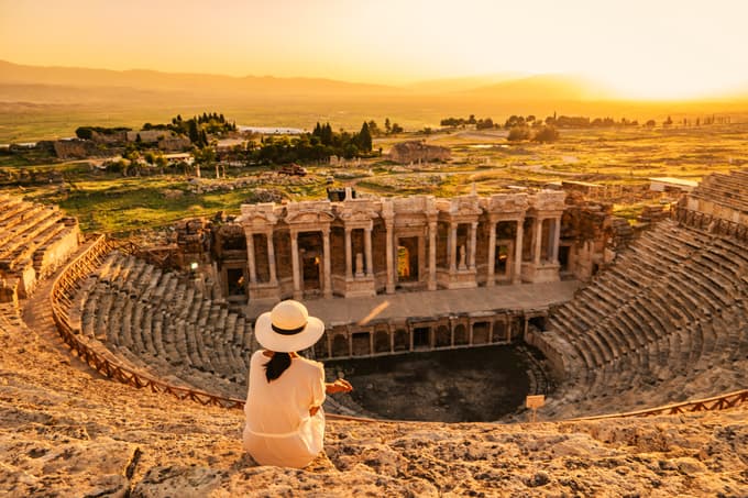 Tourist enjoying sunset at the old Amphitheater