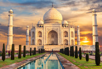 Witness the Taj Mahal glow softly under the golden hues of sunrise