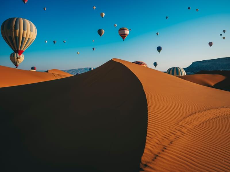 The sky full of hot air balloons over Dubai desert