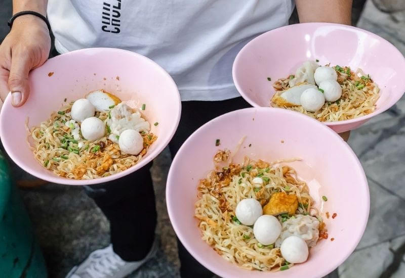 Savor flavorful noodles with fish balls and egg on this food tour