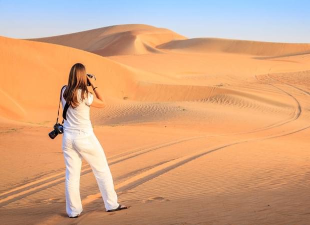 Tourist enjoying her time in Dubai sand dunes
