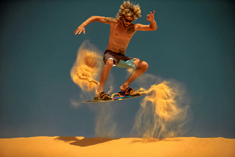 Conquer the dunes with adrenaline-pumping sandboarding adventure