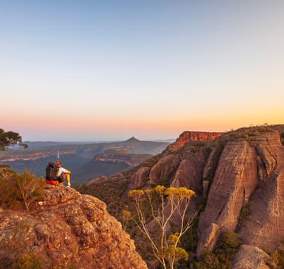Marvel at the scenic surroundings as you ascend to rocky mountains in Uluru