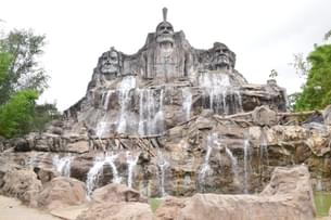 Admire the breathtaking cascade of water as it plunges into the serene surrounding