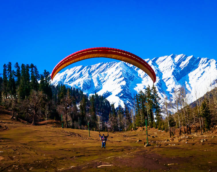 Soar through the majestic Himalayas on your paragliding adventure