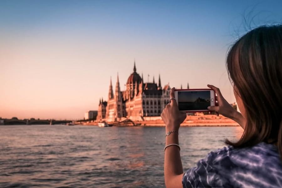 Capture the majestic beauty of the Hungarian Parliament Building as you pass by it