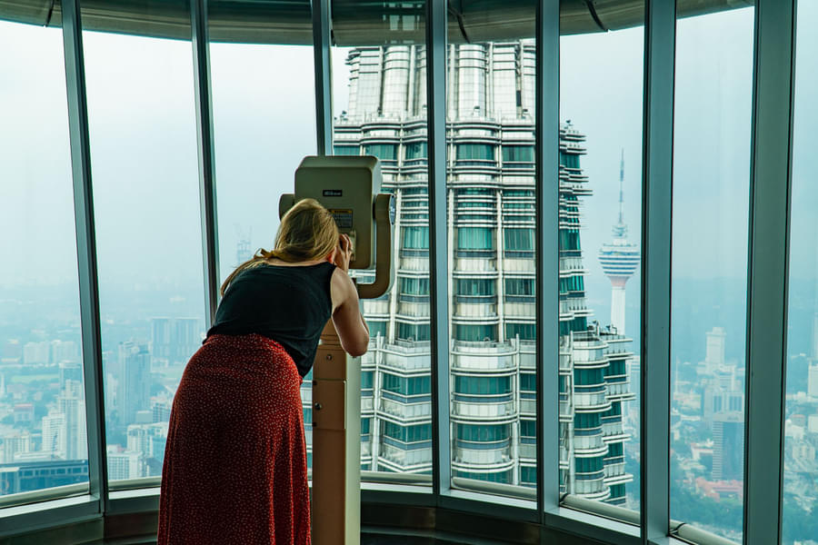 Enjoy the view of city's beautiful skyline through binoculars at the 86th floor